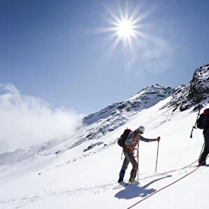 Hikers on Weissbrunnferner Mountain during the ascent to Hinterer Eggenspitz Mountain in the Val dUltimo, with the summit of Hinterer Eggenspitz Mountain at the rear, Alto Adige, Italy, Europe