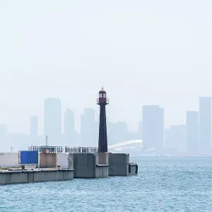 Historical Lighthouse and Dalian Bay with City Skyline in Background Historical Lighthouse and Dalian Bay with City Skyline in Background