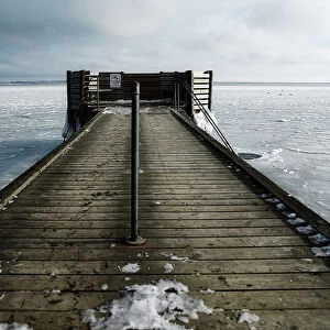 Hole in the ice for winter bathing by a jetty
