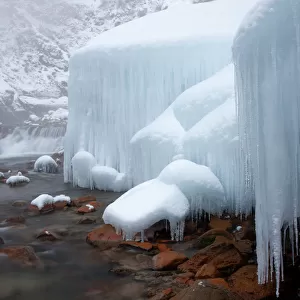 Honshu island, Nagano, Japan. Icicles and blocks of frozen snow by a stream