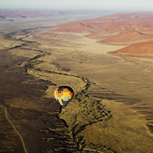 Hot air balloon over desert landscape