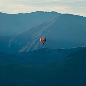 Hot air balloon flying over mountain range at Queenstown