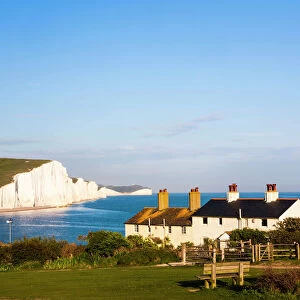 Houses in front of the Seven Sisters chalk cliffs, Seaford, Sussex, England, United Kingdom
