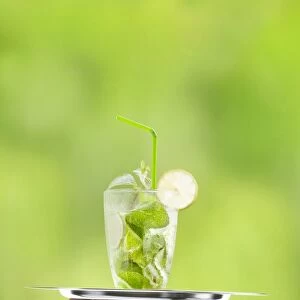 Hugo cocktail with lime and mint being served on a tray