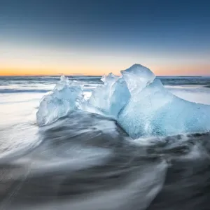 Ice on ice beach with water wave in Jokulsarlon, Iceland
