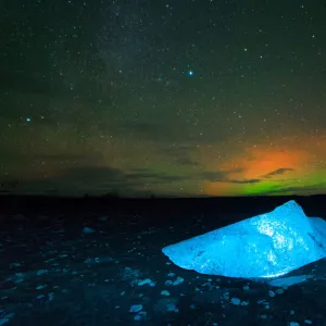 Iceberg under Aurora borealis at Jokulsarlon, Iceland