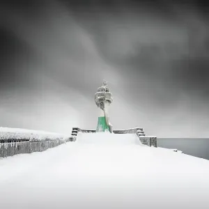Iced lighthouse in the harbour of Sassnitz, Ruegen, Germany Iced lighthouse in the harbour of Sassnitz, Ruegen, Germany