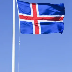 Icelandic national flag blowing in the wind, Iceland, Europe Icelandic national flag blowing in the wind, Iceland, Europe