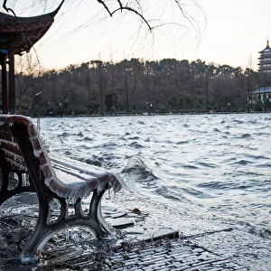 Icicles on bench against the Leifeng Pagoda by the West Lake, Hangzhou, Zhejiang, China