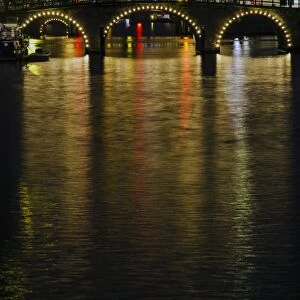 Illuminated Amsterdam Canal and Bridge