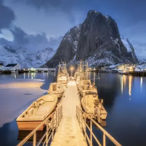 Illuminated landing stage, jetty at the harbour of the fishing village Hamnoy Polar Night Illuminated landing stage, jetty at the harbour of the fishing village Hamnoy Polar Night