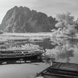 An infrared image of traditional bamboo boats on the waterways of Ninh Binh in Vietnam An infrared image of traditional bamboo boats on the waterways of Ninh Binh in Vietnam
