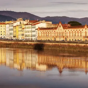 Italy, Tuscany, Pisa, Townhouses by Arno river at sunset Italy, Tuscany, Pisa, Townhouses by Arno river at sunset