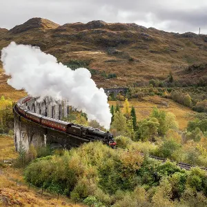 The Jacobite Steam train Crossing the Glenfinnan Viaduct in Scotland The Jacobite Steam train Crossing the Glenfinnan Viaduct in Scotland