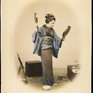 Japanese Toilette Print, a woman in kimono admires herself Japanese Toilette Print, a woman in kimono admires herself