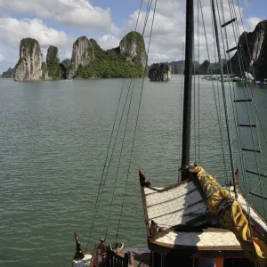 Junk boat navigating in Halong Bay Junk boat navigating in Halong Bay
