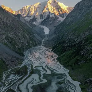 Karakol Mountain Peak and its glacial river at dusk, Issyk-Kul Region, Kyrgyzstan Karakol Mountain Peak and its glacial river at dusk, Issyk-Kul Region, Kyrgyzstan