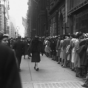 Large group of people waiting in line outdoors, (B&W)