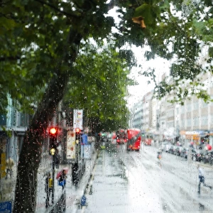 London street scene through rain-soaked bus windows, London, England, United Kingdom