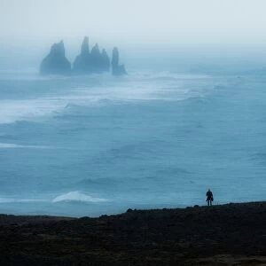 A lonely man and the unique rock of Vik, Iceland
