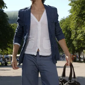 Long-haired man shopping in a city in the summer