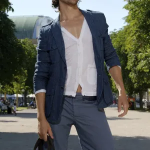 Long-haired man shopping in a city in the summer