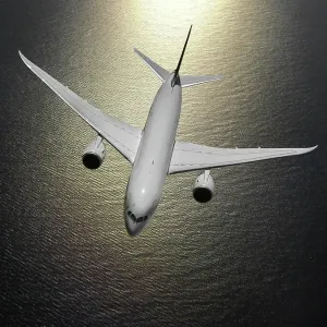 Look-down view of a Boeing 787-8 Dreamliner over the ocean Look-down view of a Boeing 787-8 Dreamliner over the ocean
