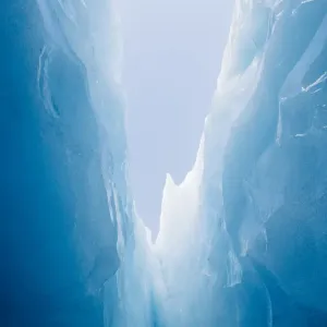 Looking up at the blue sky from deep with in a glaciers jagged crevasse Looking up at the blue sky from deep with in a glaciers jagged crevasse