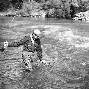 Man catching fish in river