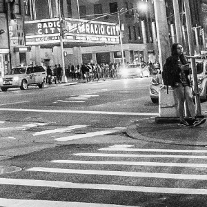 Man dancing in the street down the street from Radio City Music Hall Man dancing in the street down the street from Radio City Music Hall