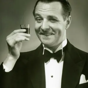 Man holding shot of alcohol Man holding shot of alcohol