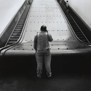 Man at bottom of Path train escalators in New York City Man at bottom of Path train escalators in New York City