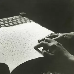Man reading braille, close up of hands