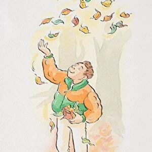 Man throwing autumn leaves in the air