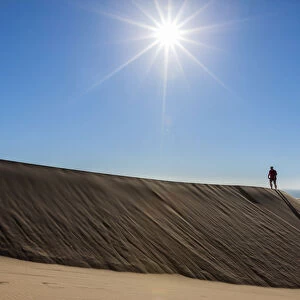 Man walking in the dune belt of Long Beach, Swakopmund, Namibia