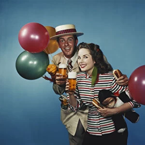 Man and woman with balloons and refreshments
