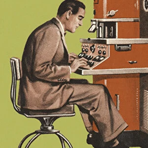 Man Working at a Control Panel