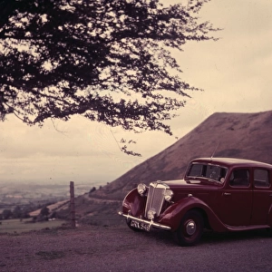 A maroon Triumph Car at a preview of the Motor Show 1952