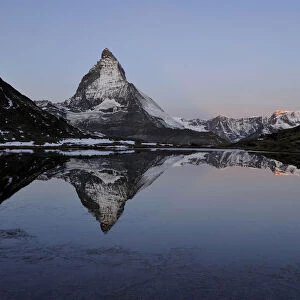 Matterhorn reflected in Lake Riffelsee, Zermatt, Valais, Switzerland, Europe