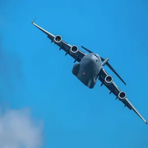 McDonnell Douglas/Boeing C-17 Globemaster III American Air Force cargo plane flying against sky McDonnell Douglas/Boeing C-17 Globemaster III American Air Force cargo plane flying against sky