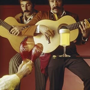 Men playing guitar and maraca