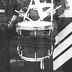Military band drummer, reflection in window, (B&W), (mid section)