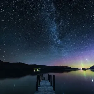 The Milky Way and Aurora Borealis from a jetty over Derwent water. English Lake District. UK The Milky Way and Aurora Borealis from a jetty over Derwent water. English Lake District. UK