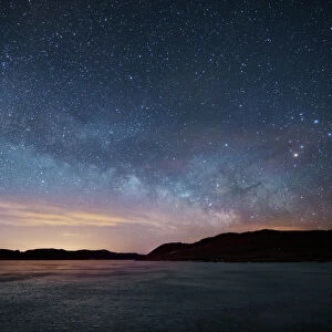 Milky Way floats above frozen lake, Front Range, Colorado, USA