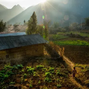 One minority child coming to a village, Vietnam One minority child coming to a village, Vietnam
