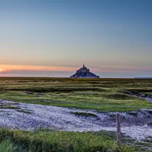 Mont-Saint Michel and meadows at sunset