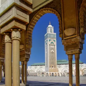 Mosque of Hassan II and minaret through the arches of the square outside it in Casablanca