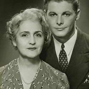 Mother and adult son, formal portrait, in studio, (B&W), portrait
