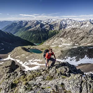 Mountaineer during the ascent of Mt Grawand, Ortler Alps at the back, Val Senales below with the Vernagt Reservoir, Meraner Land area, Merano, Meran region, South Tyrol, Italy