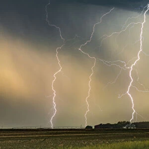 Multiple Lightning strikes hit a ranch in Nebraska at sunset, USA
